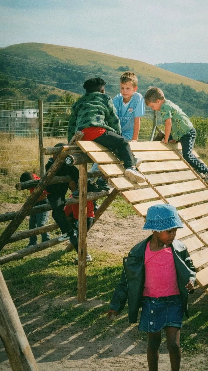 Children climbing on the play frame at the Mbotyi ECD
