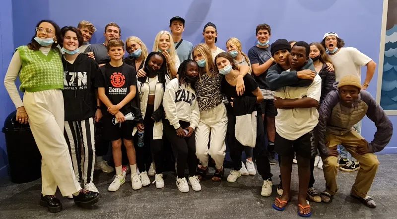 A big group of teenagers and leaders pulling faces for the camera