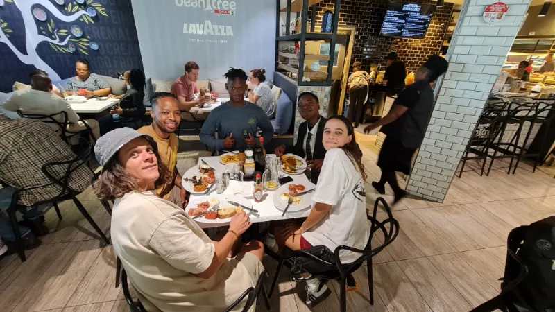 Students and mentors sharing a meal at a restaurant
