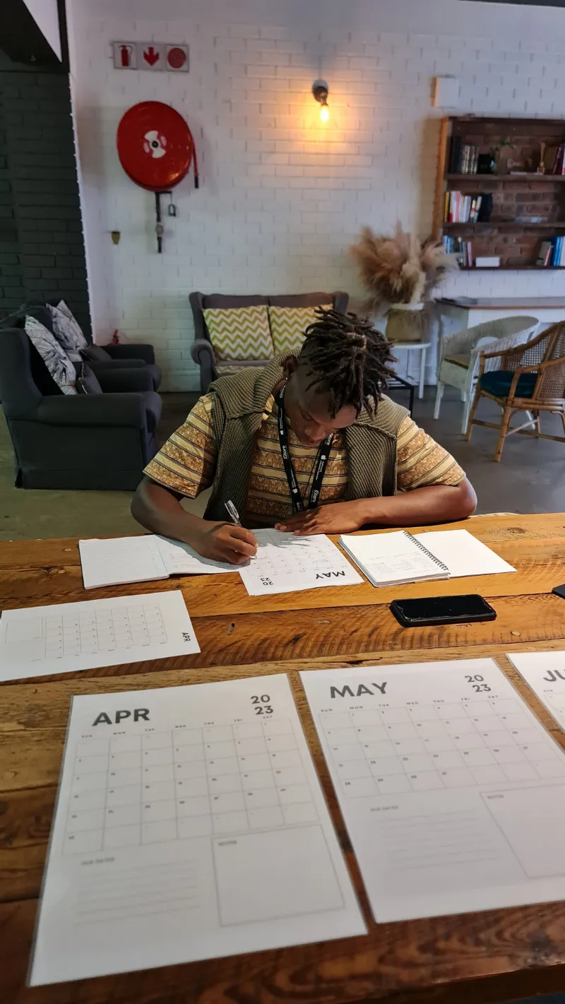 A student writing in a study planner