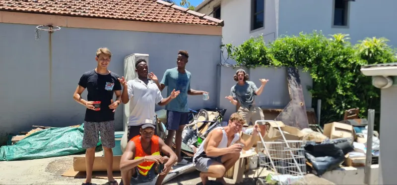 Young men from the Youth of Hope House hanging out in the yard